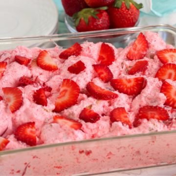 glass baking pan filled with a strawberry fluff dessert