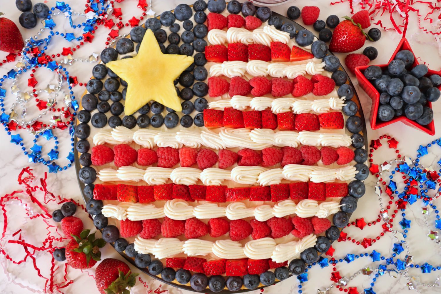 Round fruit pizza made to resemble the American flag