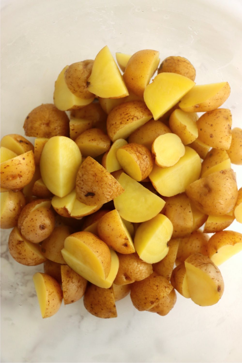 Bowl of boiled yellow potatoes.