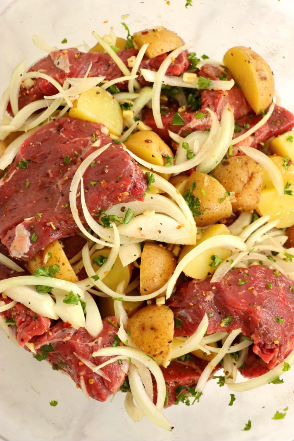 steak pieces mixed with onions, potatoes and seasonings.