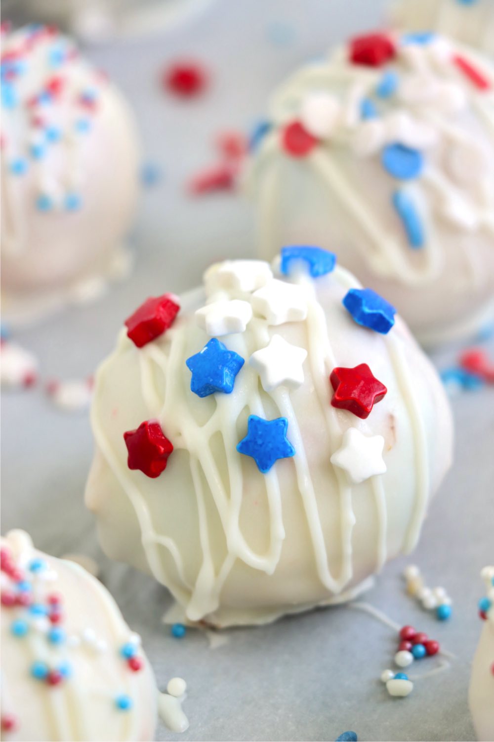 White chocolate covered truffle with red, white and blue star sprinkles.