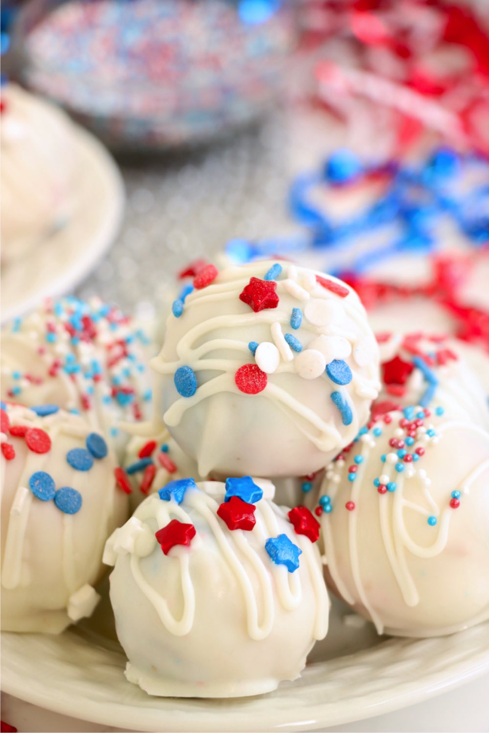Stack of vanilla coated truffles covered with patriotic sprinkles.
