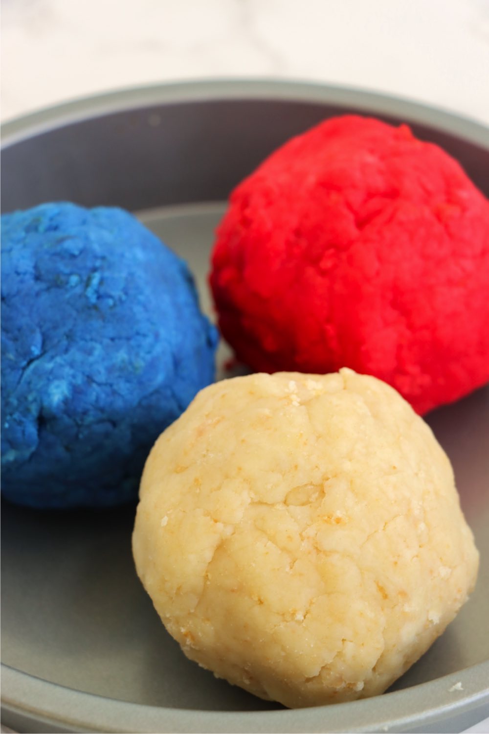 Red, white and blue balls of cake batter.