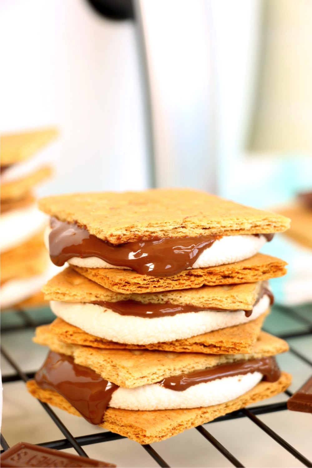 Stack of s'mores with an air fryer in the background.