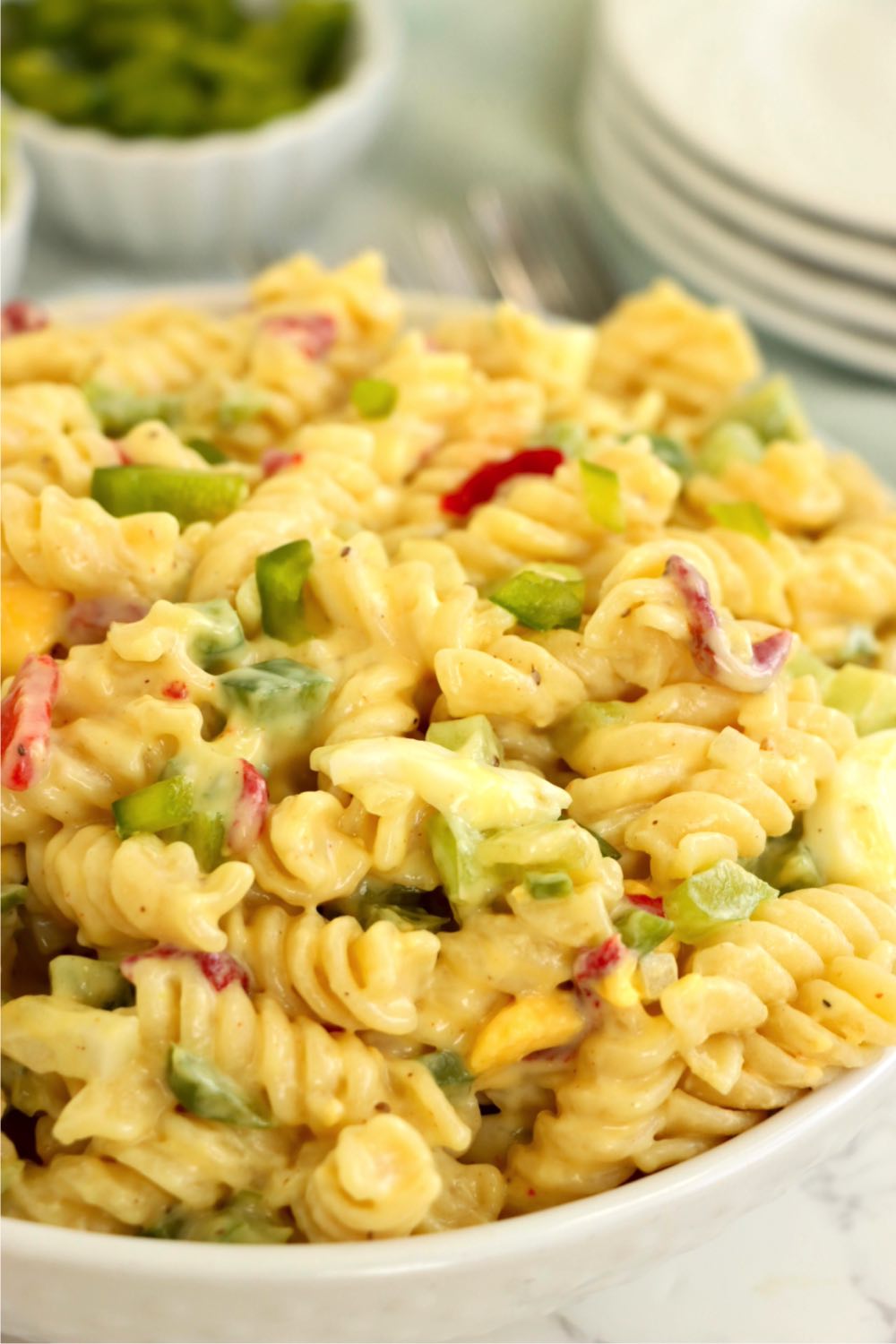 A colorful pasta salad with creamy dressing and fresh cut vegetables.