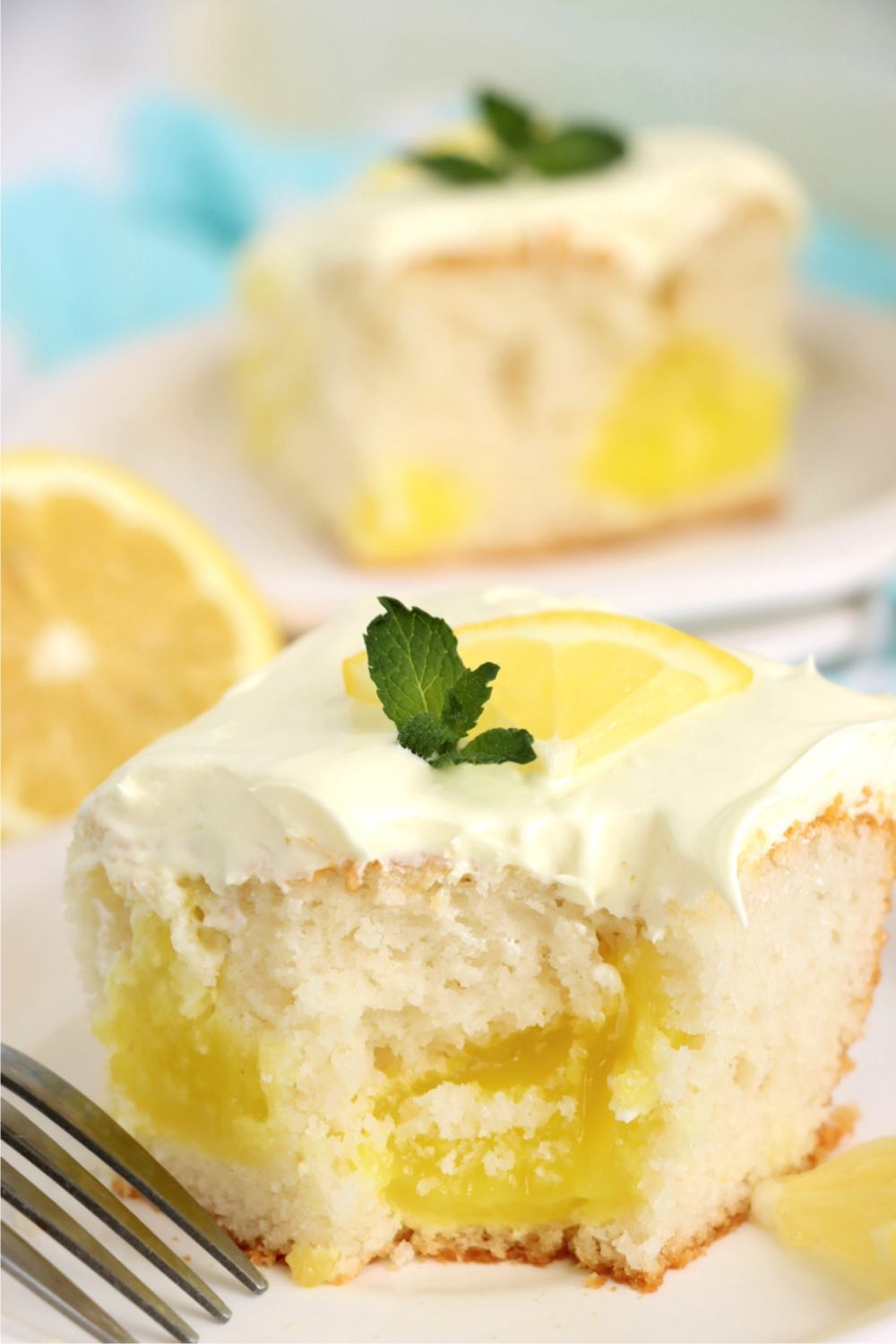 Piece of lemon cake with a bite out.