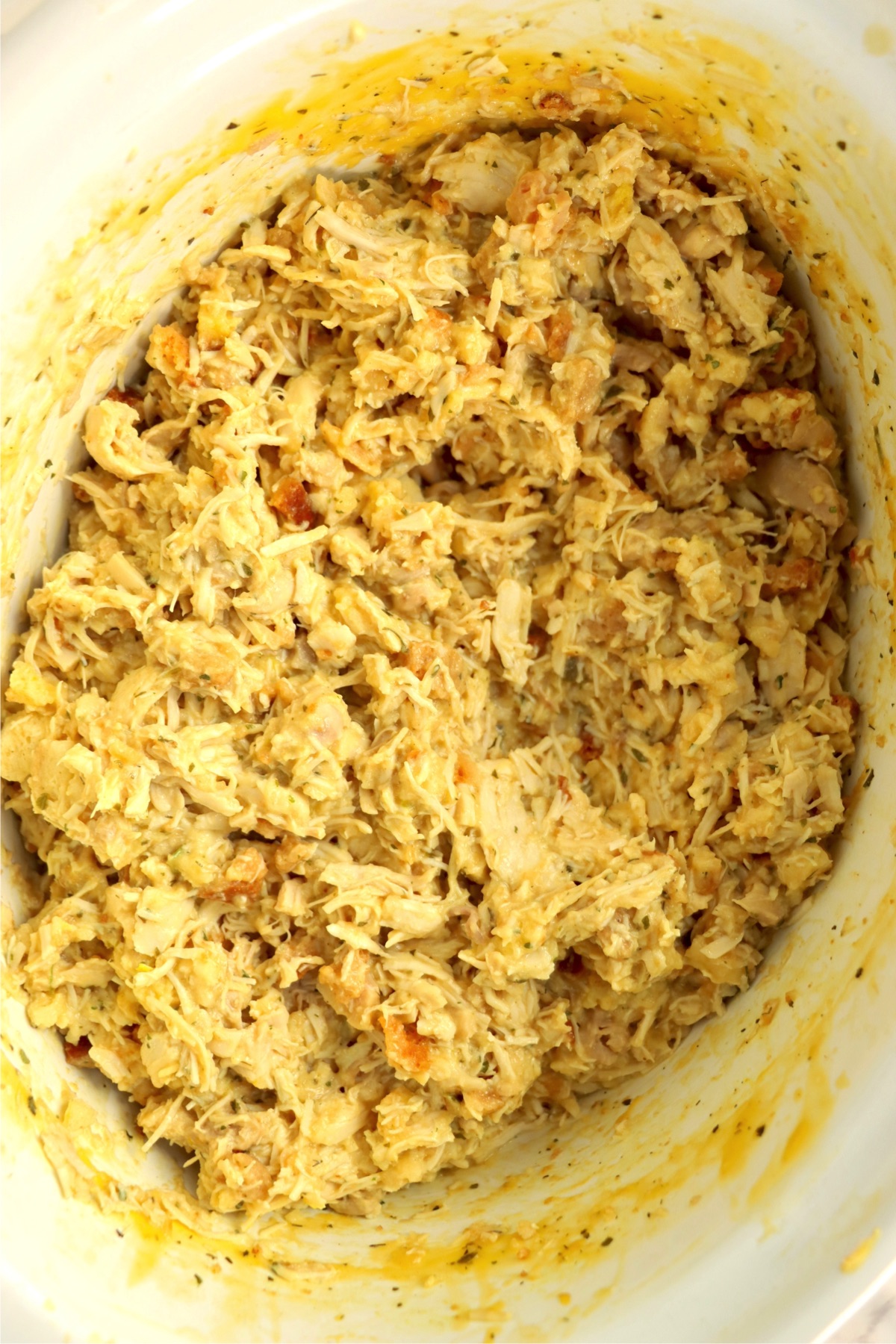 Creamy shredded chicken in a crock pot.