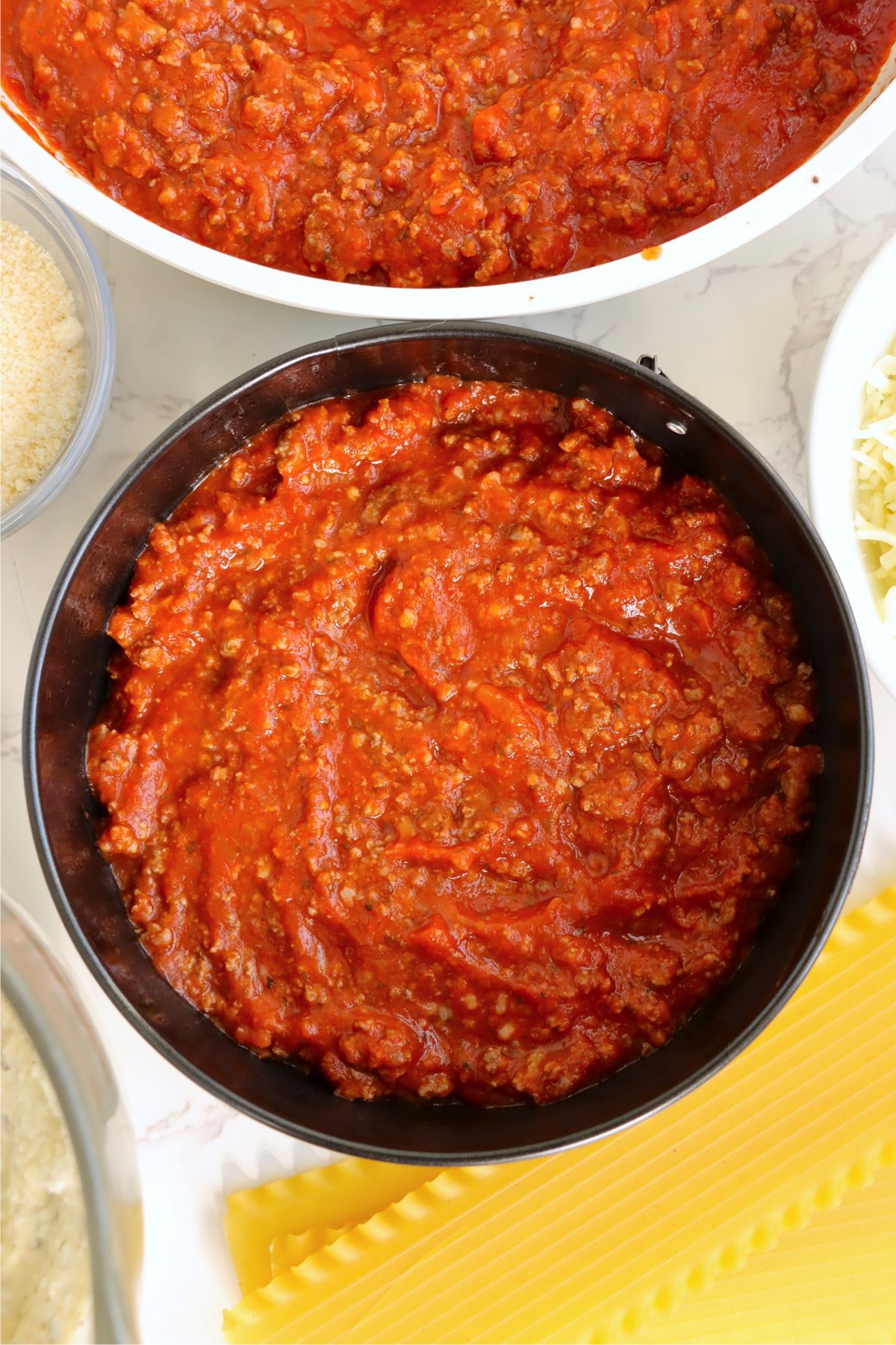 Meat sauce in a small round baking pan.