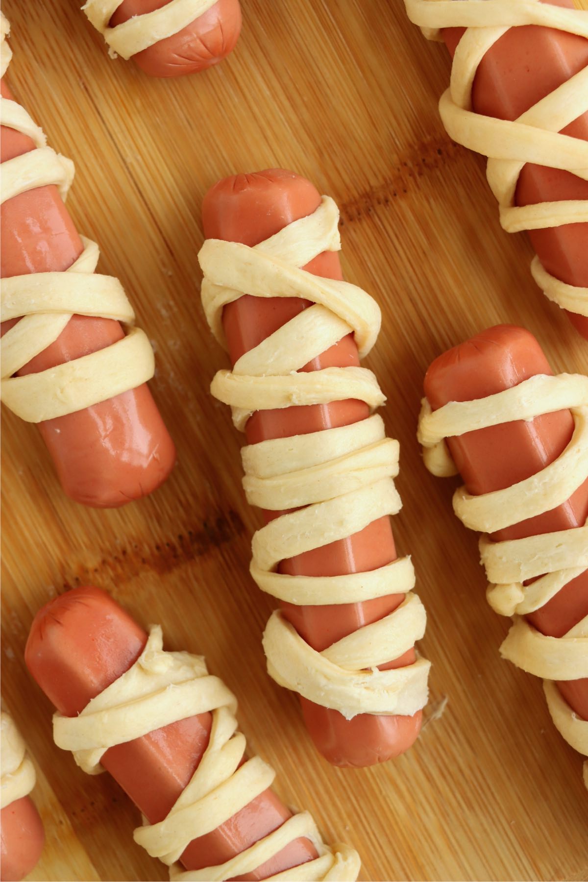 Hotdogs wrapped in strips of crescent rolls.