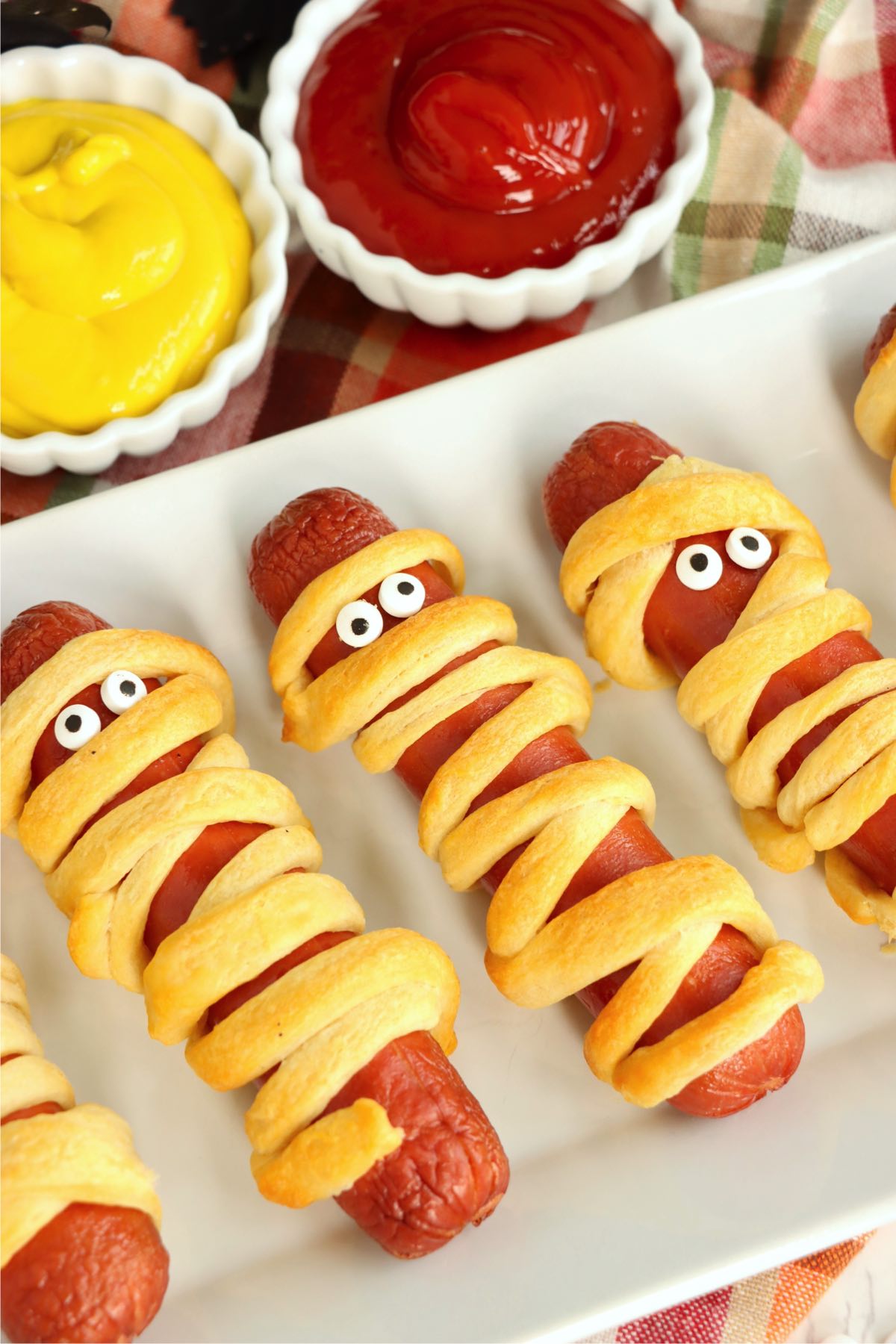 Hotdogs wrapped in crescent roll strips made to look like mummies for Halloween.