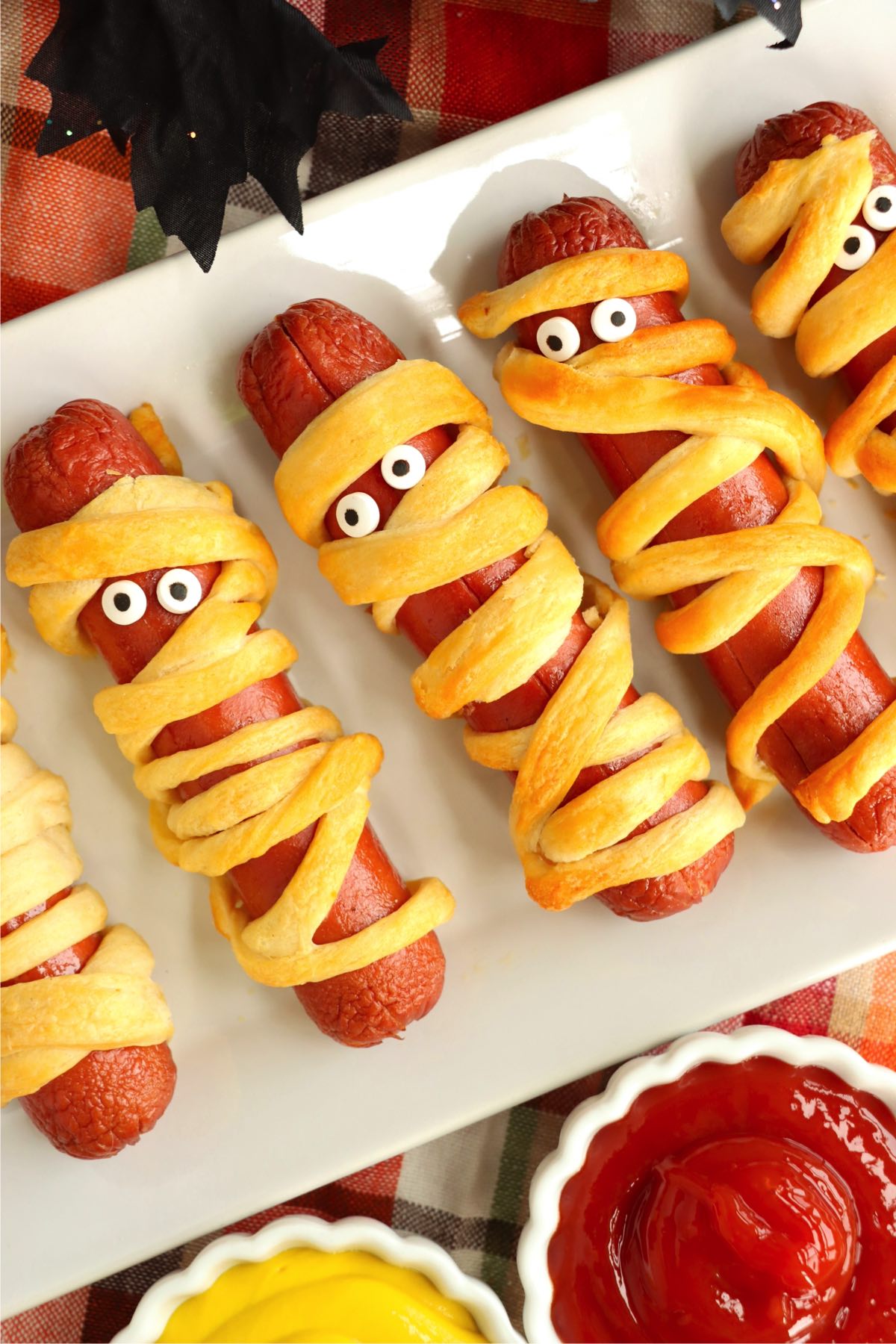 Hot dogs wrapped in strips of crescent rolls to look like Halloween mummies.