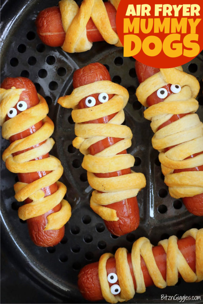 Halloween mummy dogs in an air fryer basket.