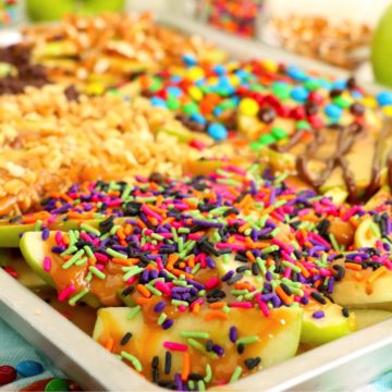 Sheet pan filled with Granny Apple slices and covered in caramel and toppings.