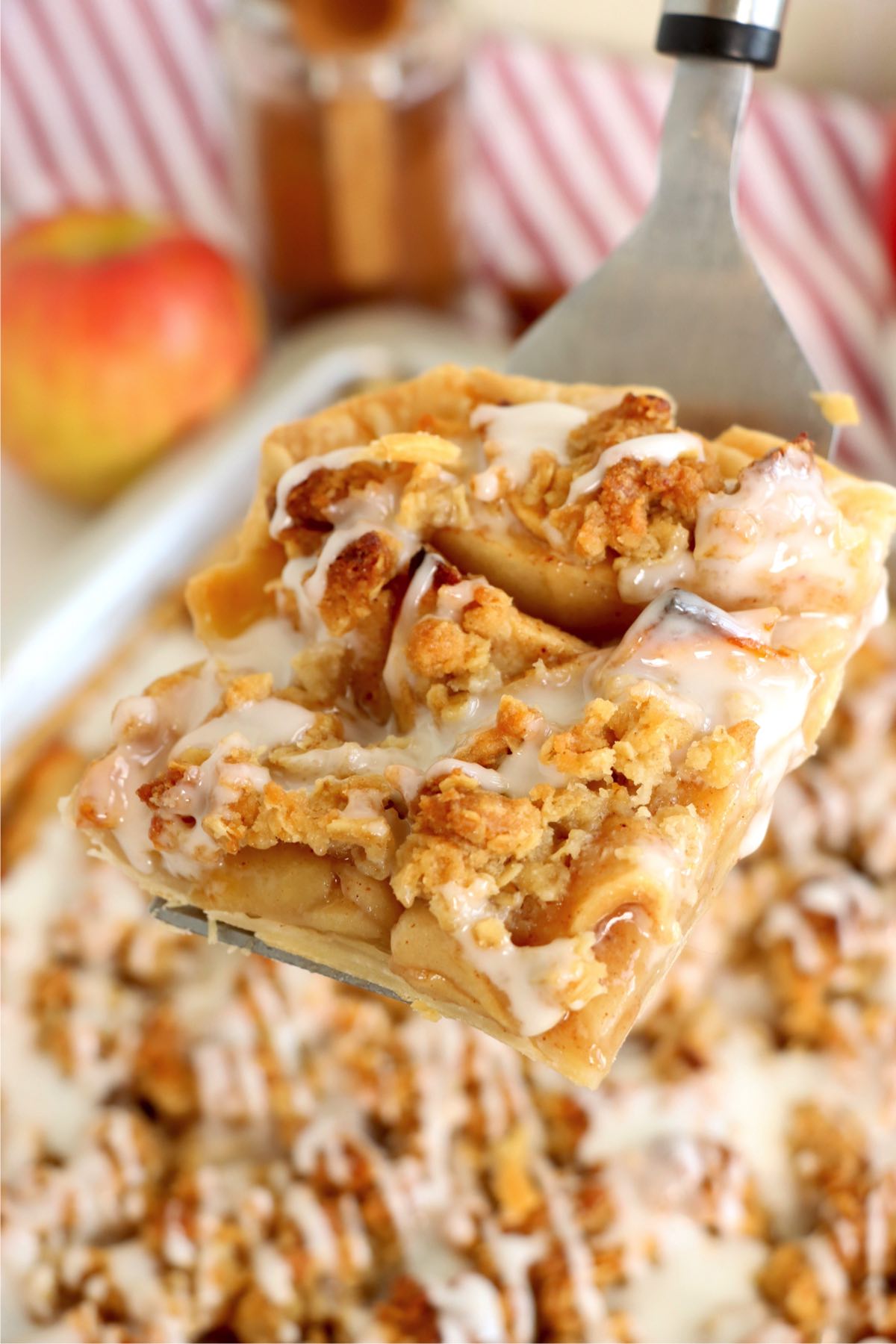 Pie server holding a piece of apple slab pie.