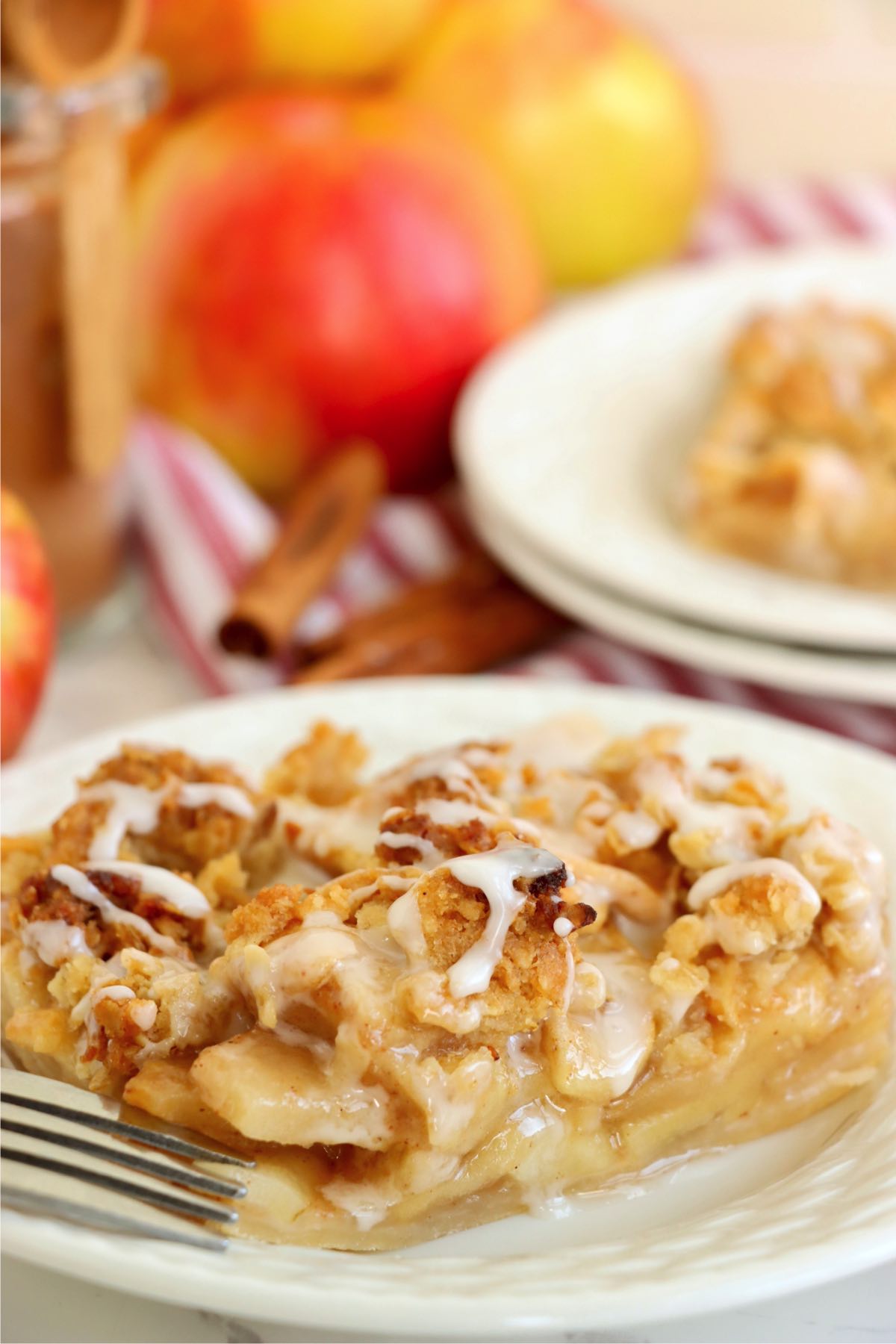 Slab of sheet pan apple pie on white plate.