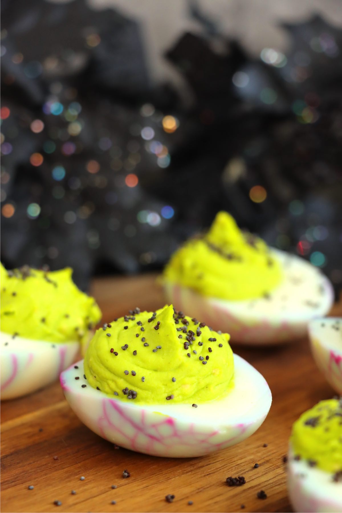 Purple spiderweb deviled eggs with a neon green filling.