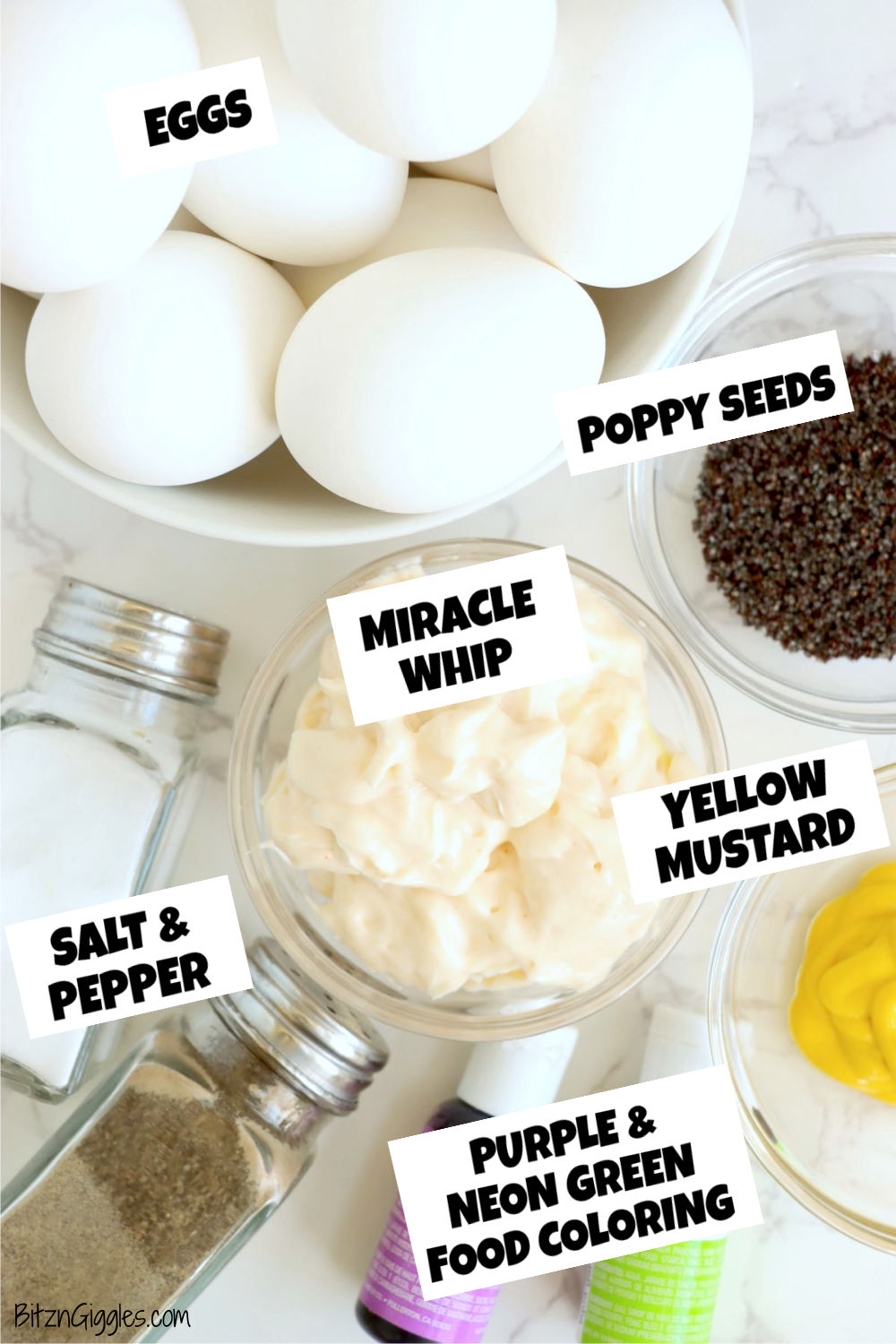 Ingredients for making Halloween deviled eggs sitting on a white marble tabletop.