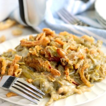 Plate of green bean casserole covered with crispy fried onions.