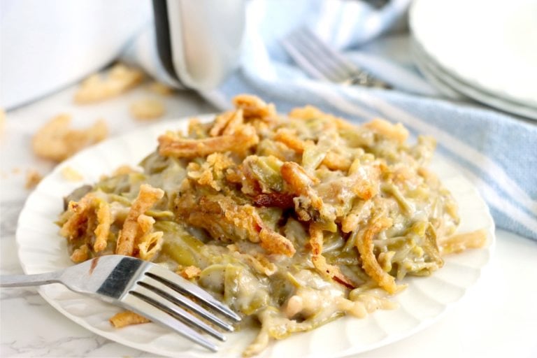 Plate of green bean casserole covered with crispy fried onions.
