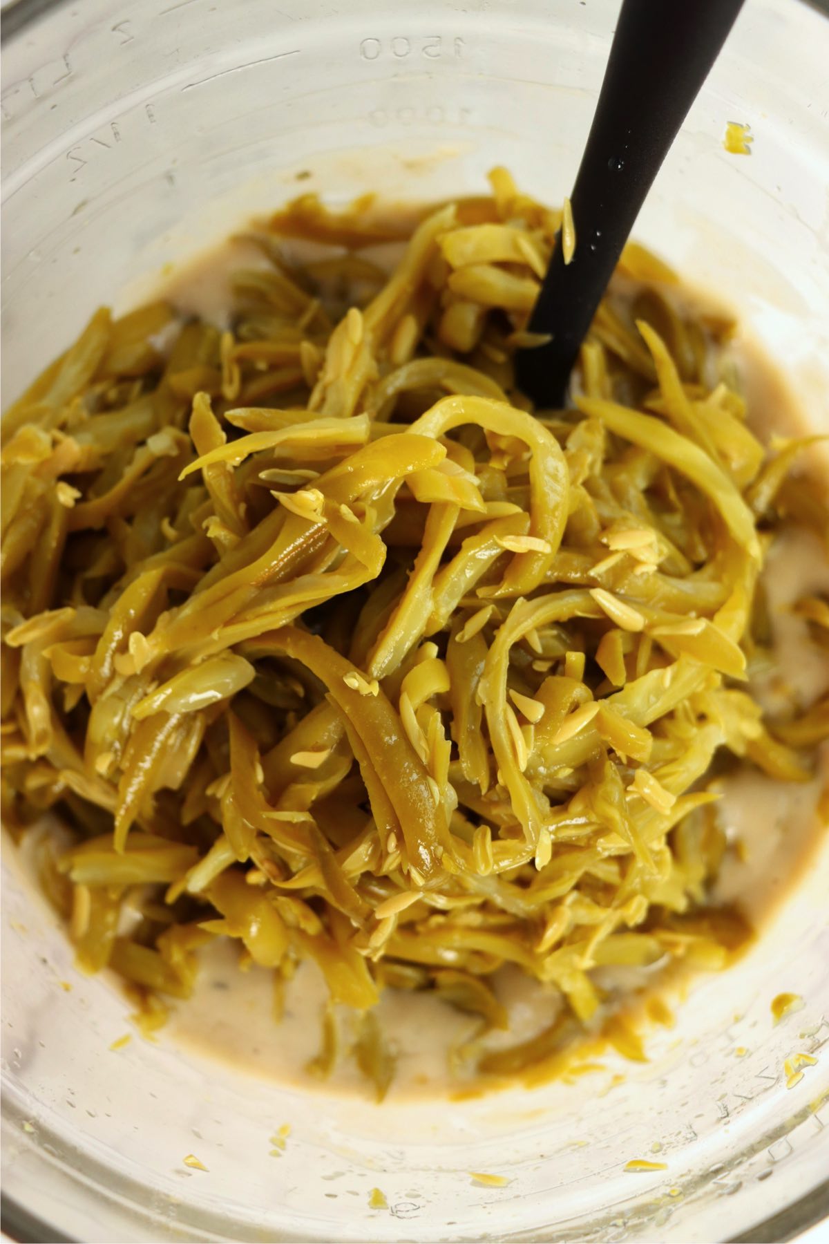 Glass bowl filled with French cut green beans.