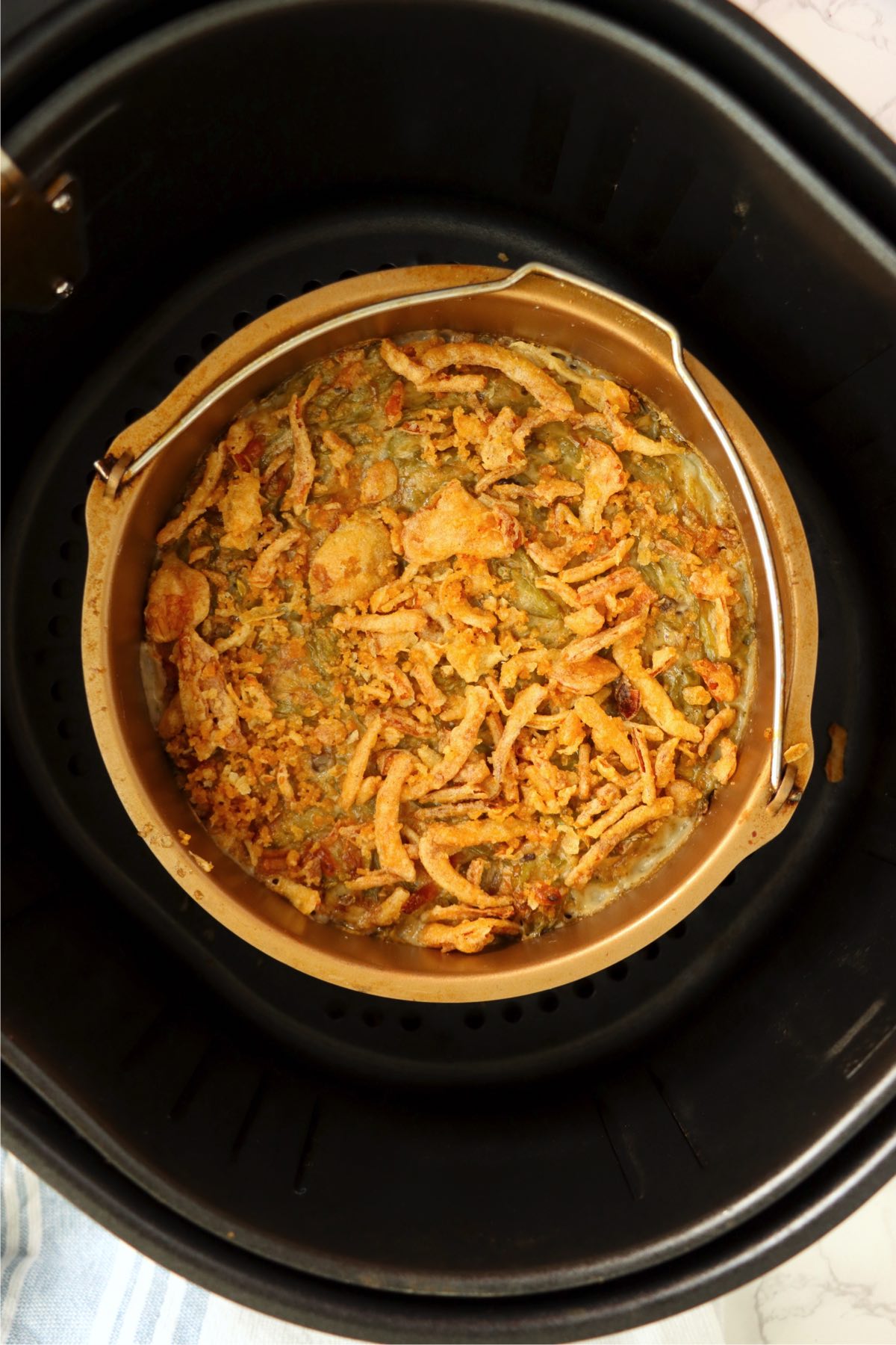 Baked bowl of green bean casserole in an air fryer.