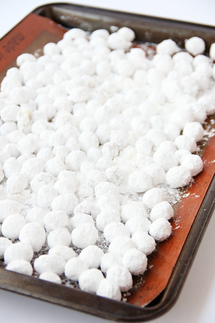 Cranberries covered in powdered sugar on baking pan.