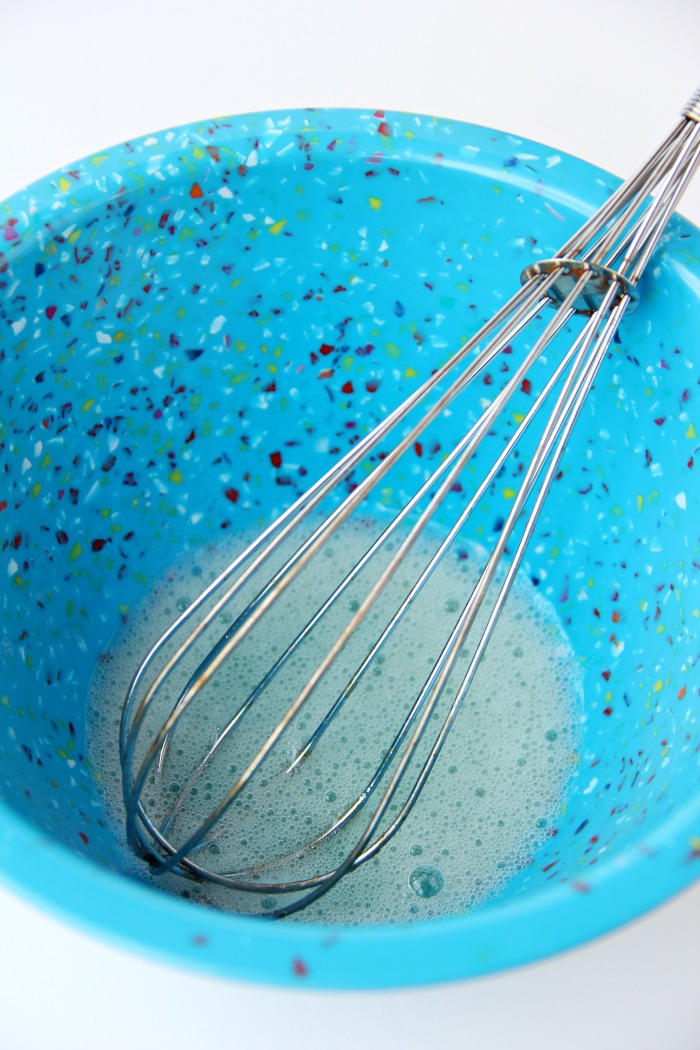 Egg whites in mixing bowl with whisk.