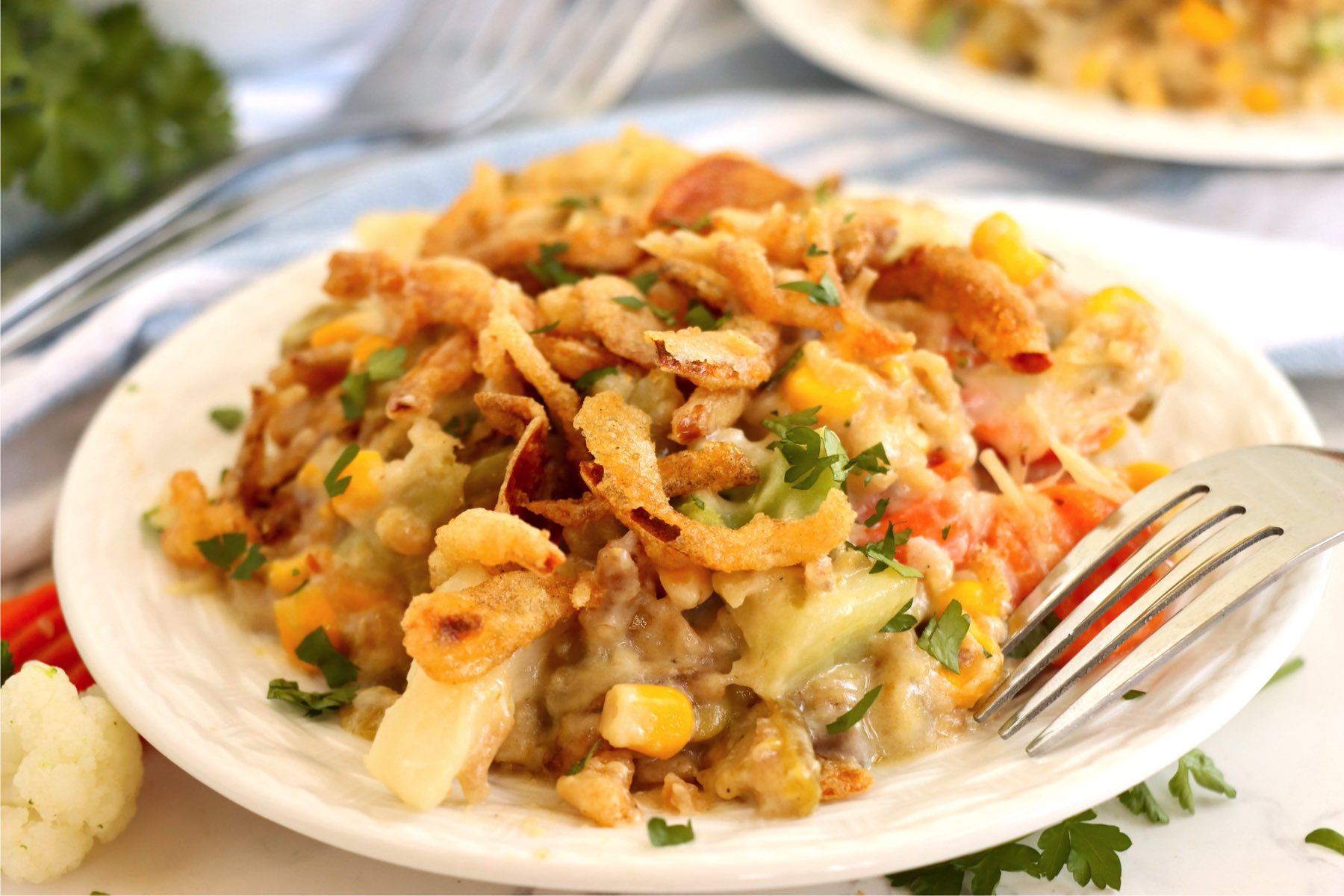 A heaping plate filled with colorful veggie casserole.