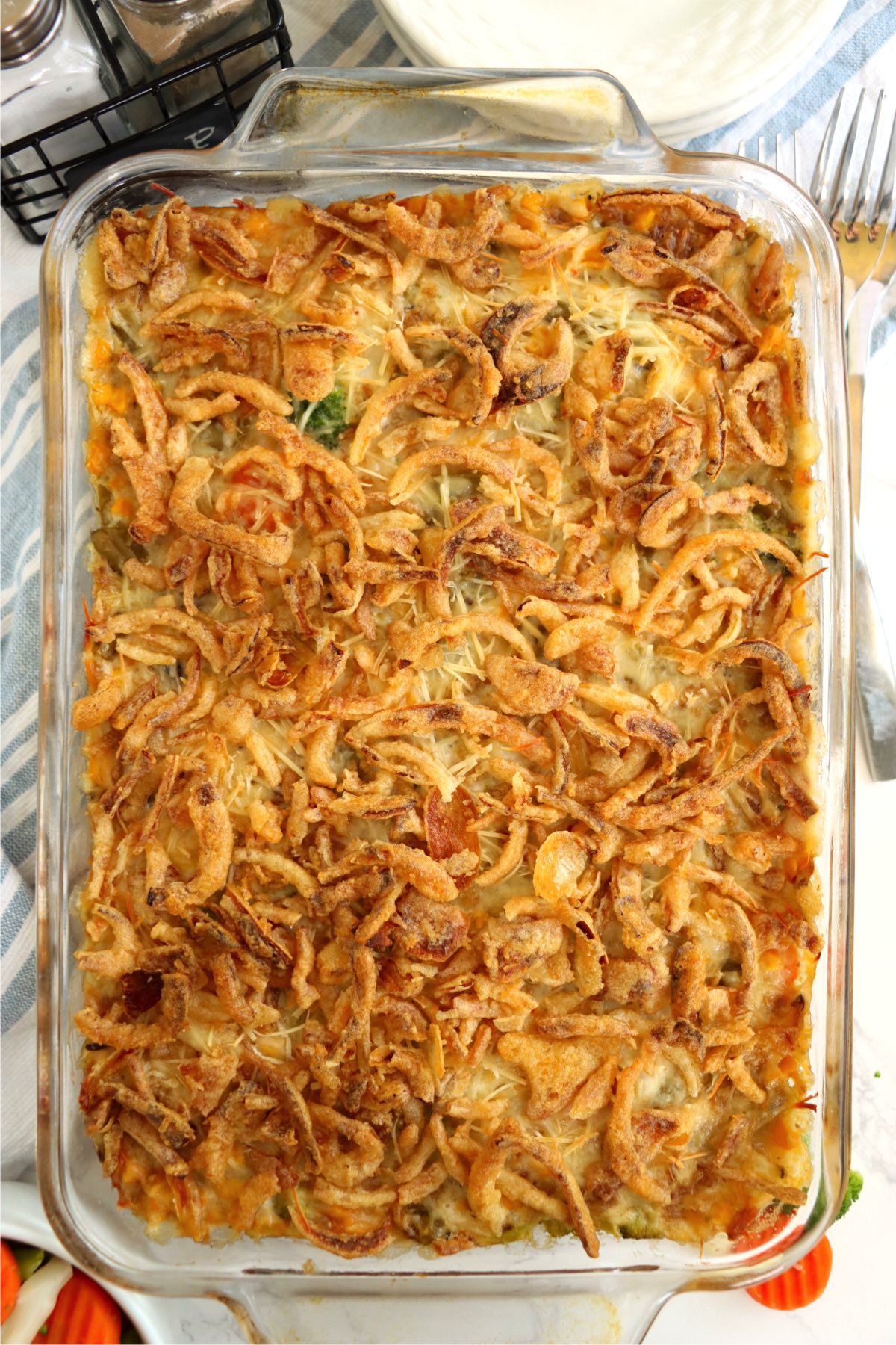 Pan of cooked vegetables topped with crispy fried onions.