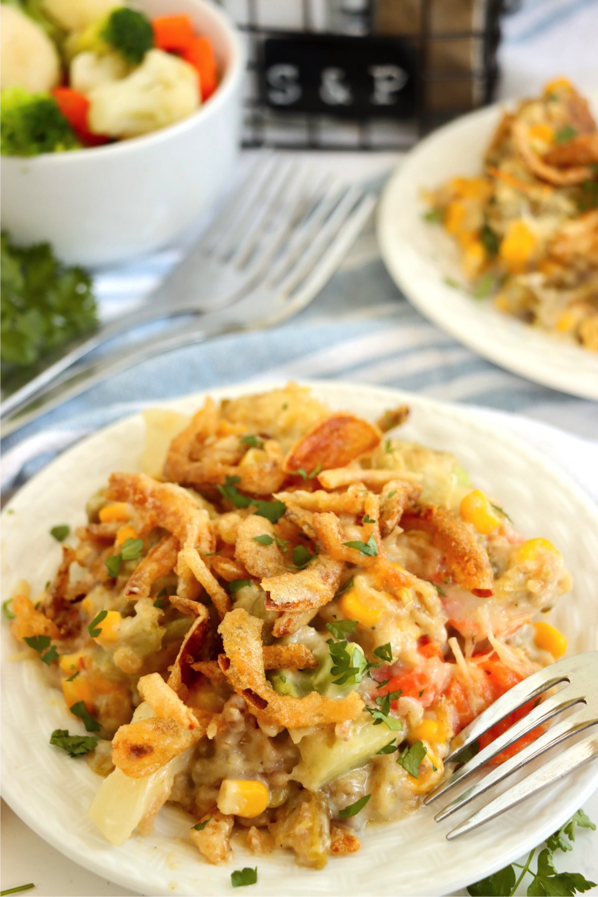 Plate filled with a veggie casserole topped with French fried onions.