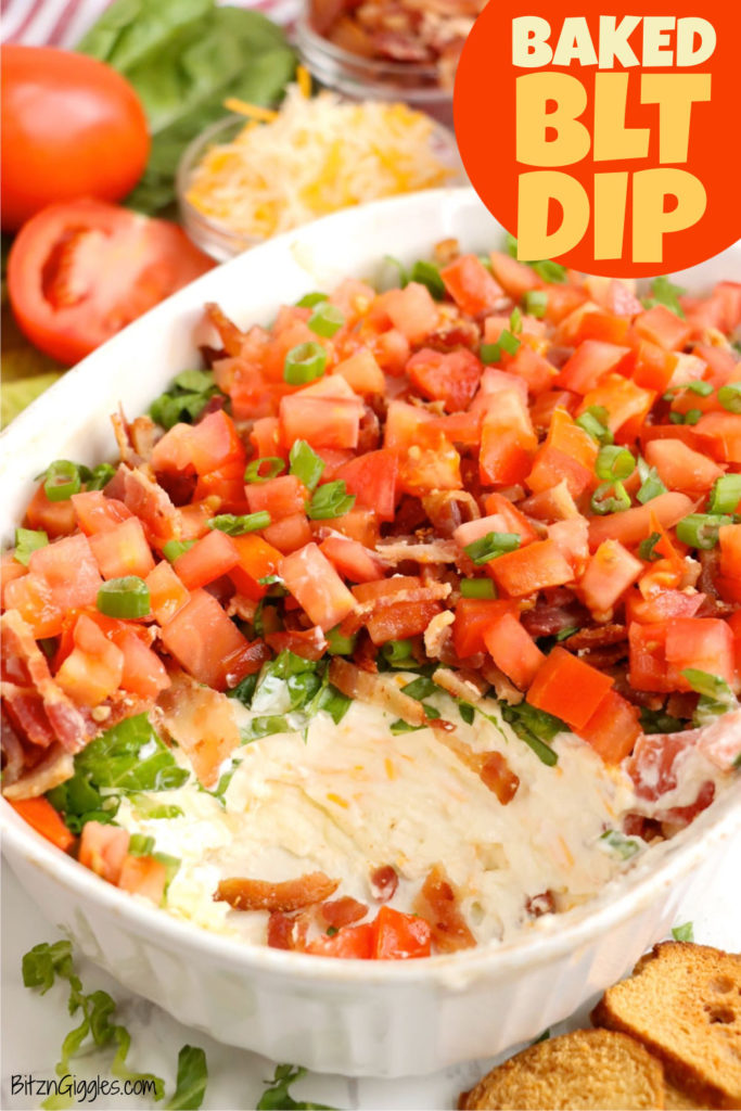 A freshly baked BLT dip in a white casserole dish, oozing creamy goodness and topped with a delicious medley of bacon, lettuce, and tomatoes.