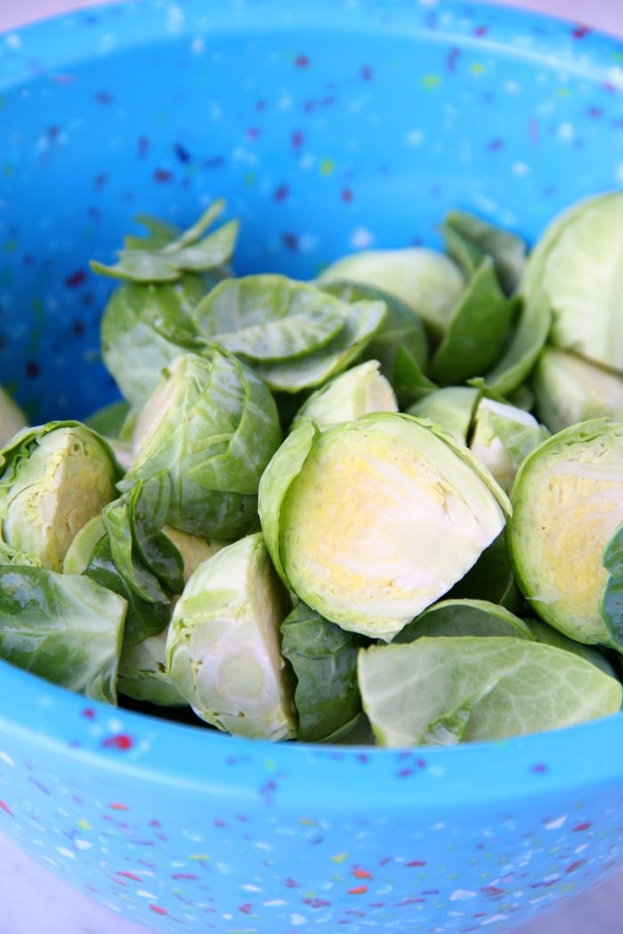 Washed and cut brussels sprouts in mixing bowl.