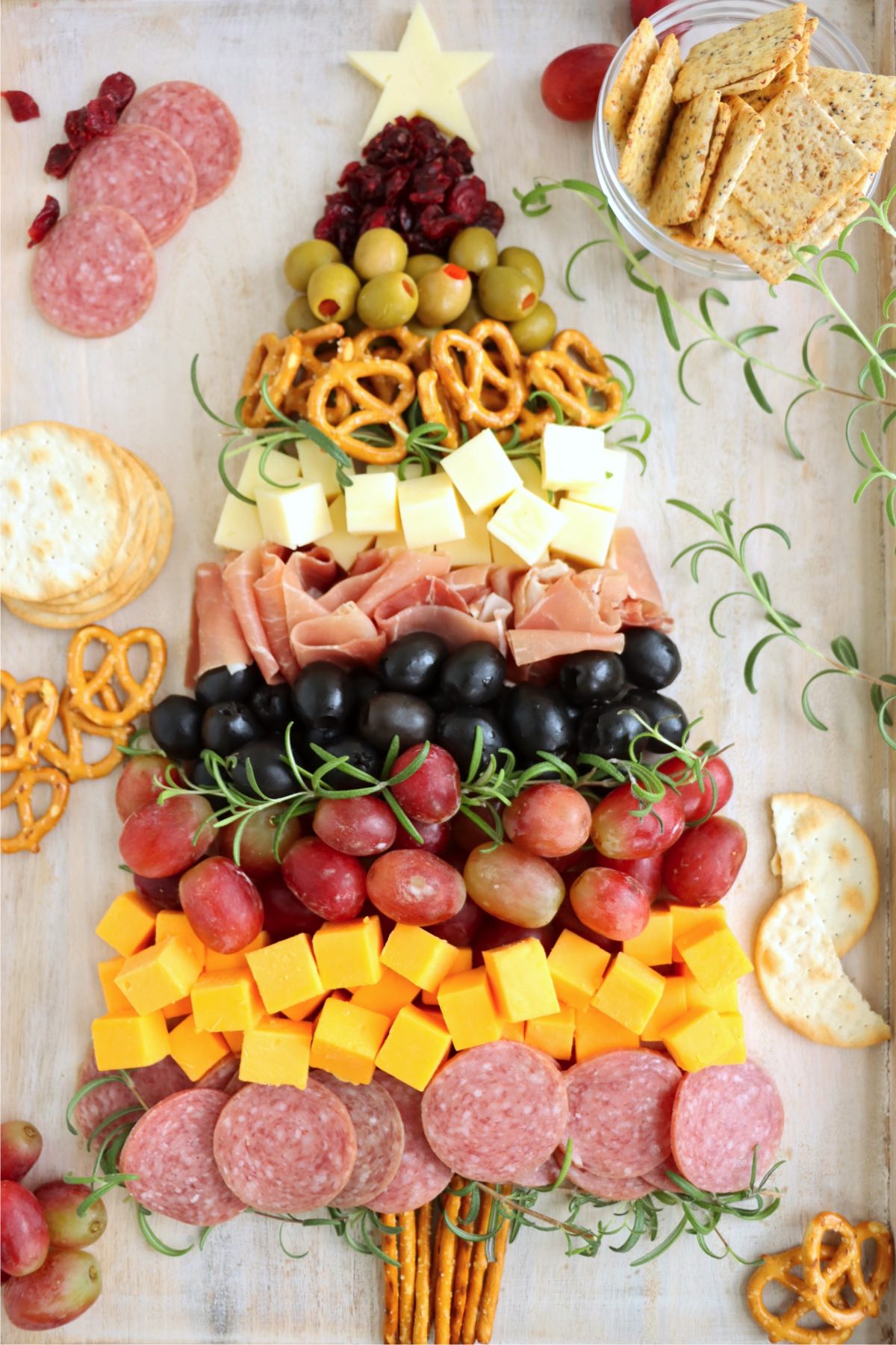 A holiday charcuterie tree with meats, cheeses, and pretzels, perfect for parties and festive gatherings.