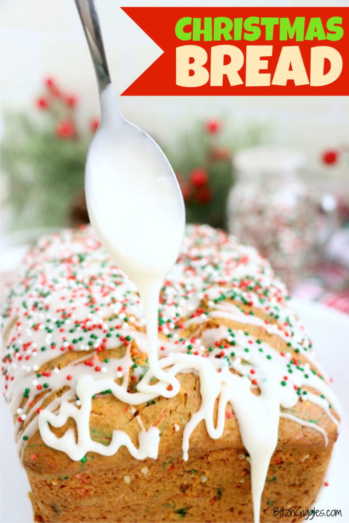 Spoon drizzling white icing over a loaf of sprinkle-topped Christmas bread.