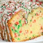 Loaf of Christmas bread on a white plate with the end cut off.