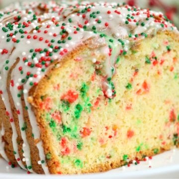 Loaf of Christmas bread on a white plate with the end cut off.