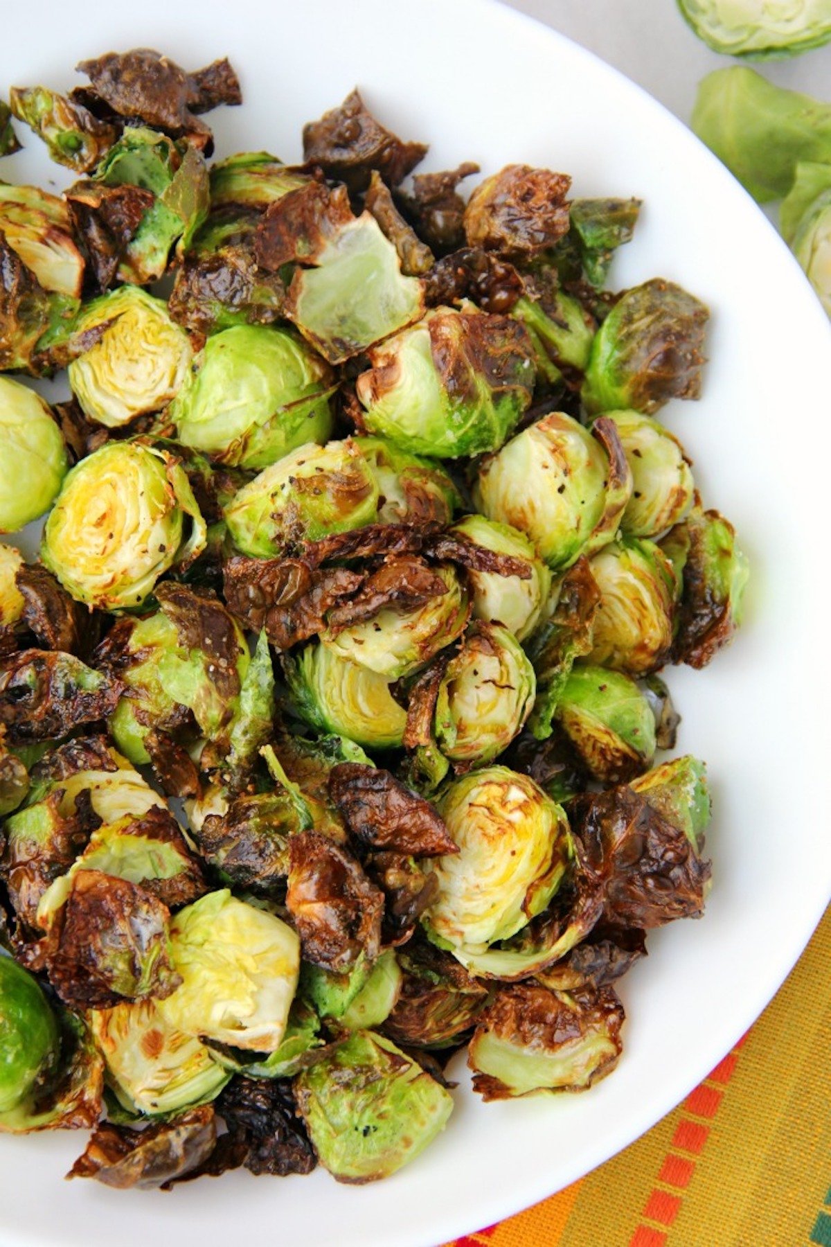 Honey and balsamic Brussels sprouts on white plate.