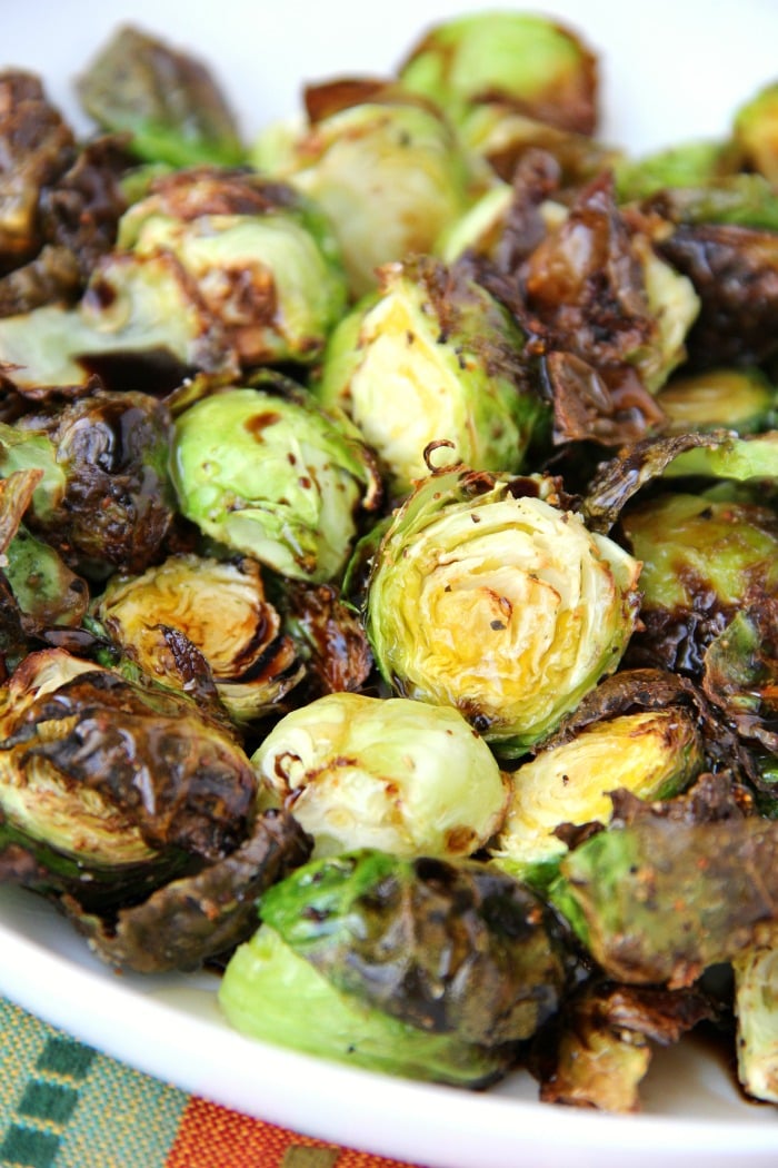 Air fried honey balsamic brussels sprouts on white plate.