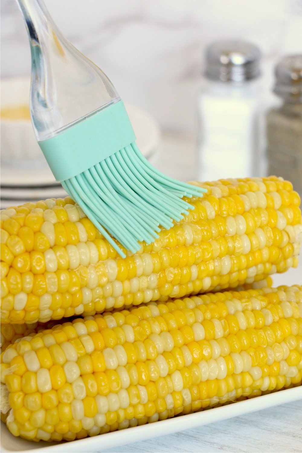 Brushing butter on ninja foodie corn on the cob.