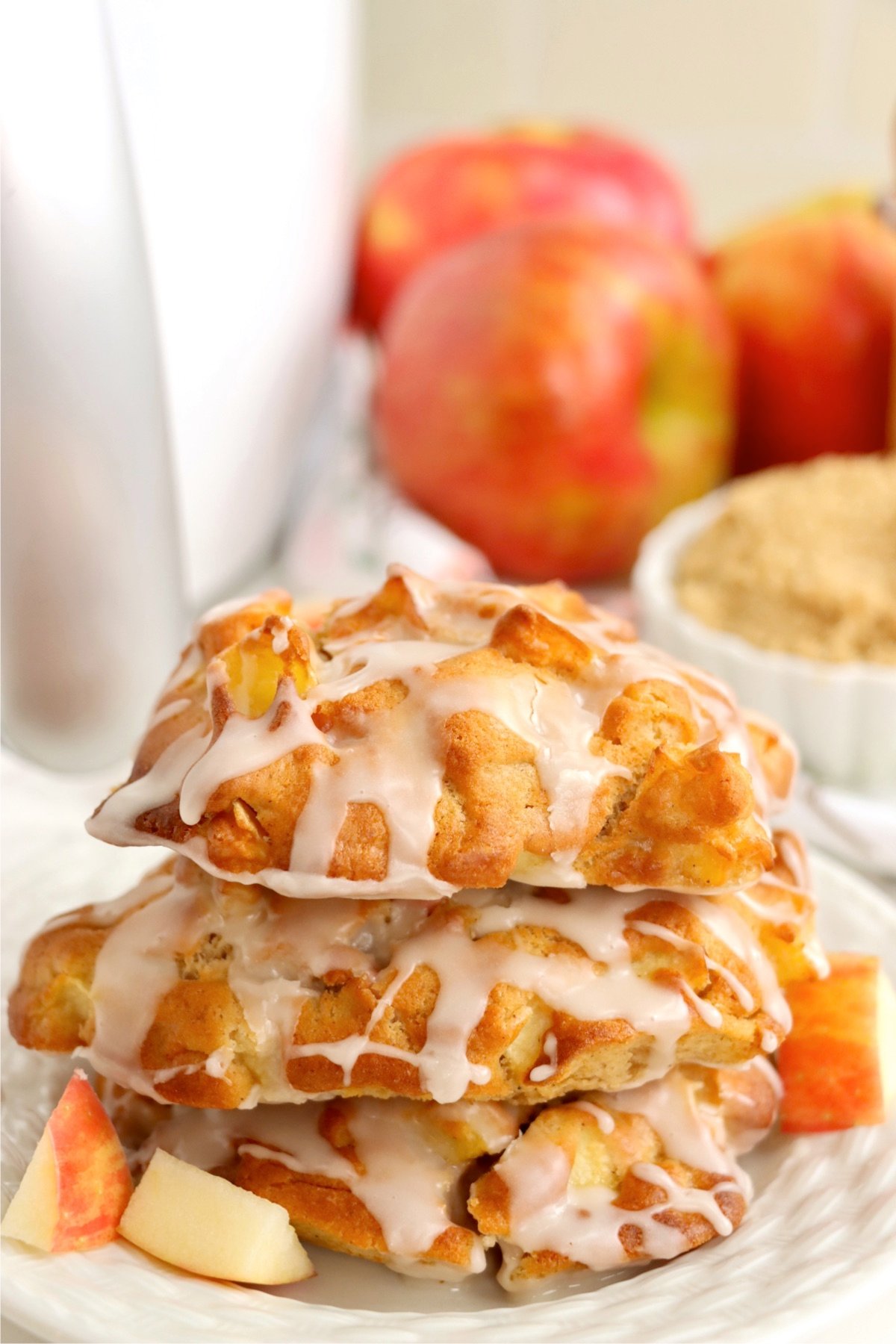 Small stack of air fryer apple fritters on a white plate.