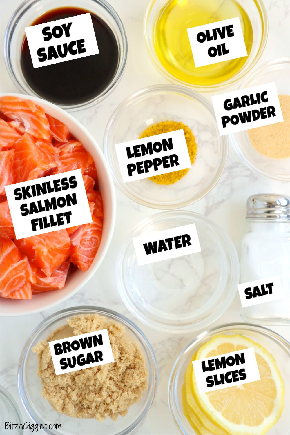 Ingredients for making salmon bites laid out in small bowls on a white table.