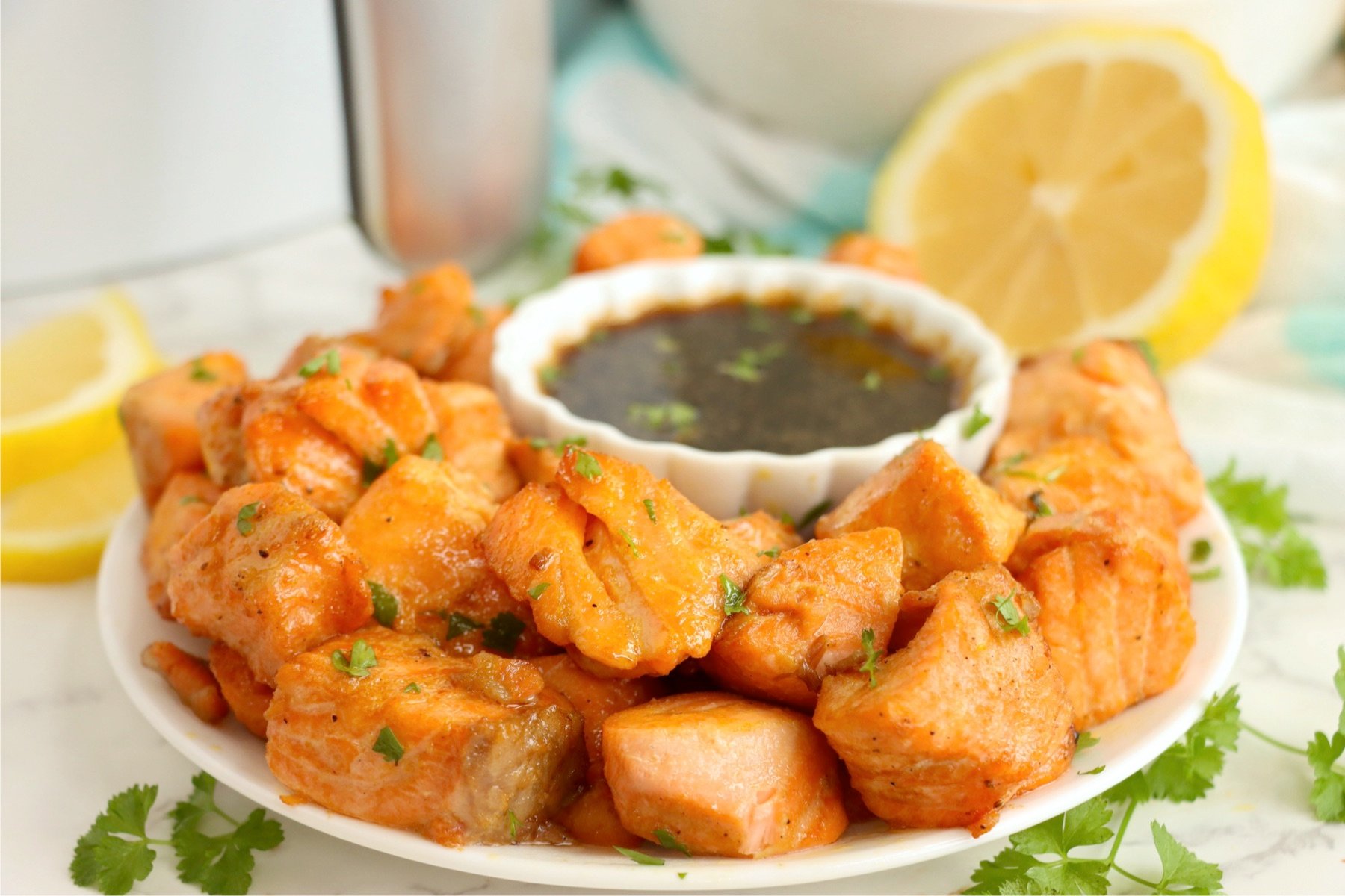 Marinated salmon bites cooked to perfection and served with a delicious dipping sauce.