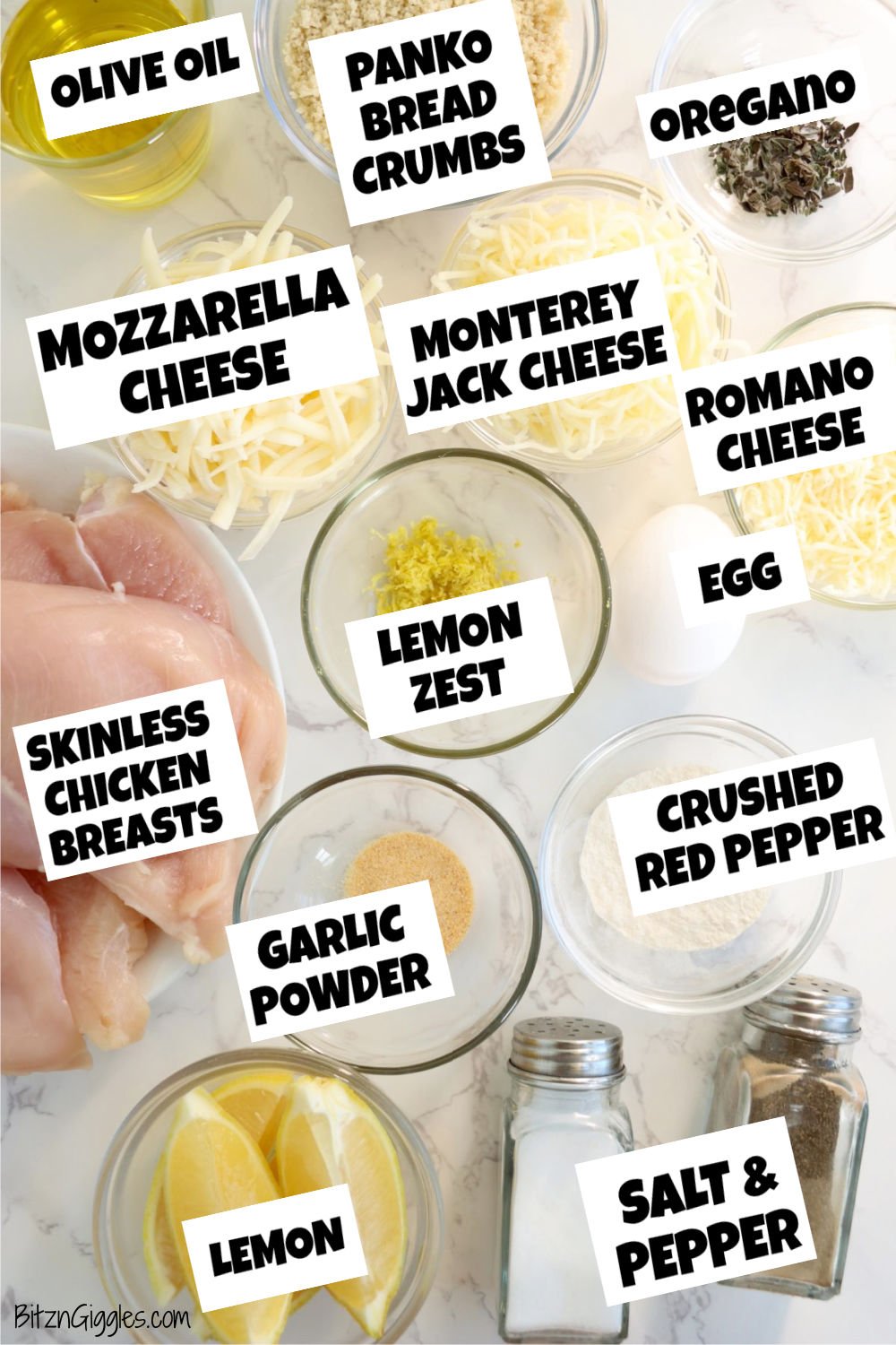 Neatly arranged Lemon Chicken Romano ingredients, including raw chicken, cheeses, panko, herbs, lemon, egg, olive oil, flour, and seasonings in glass bowls.