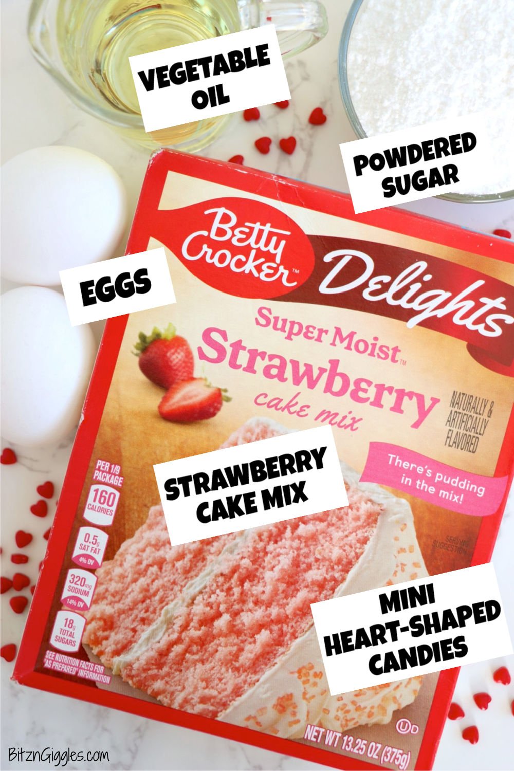 A box of Betty Crocker Strawberry Cake Mix with vegetable oil, eggs, powdered sugar, and heart sprinkles, ready for cookie baking.