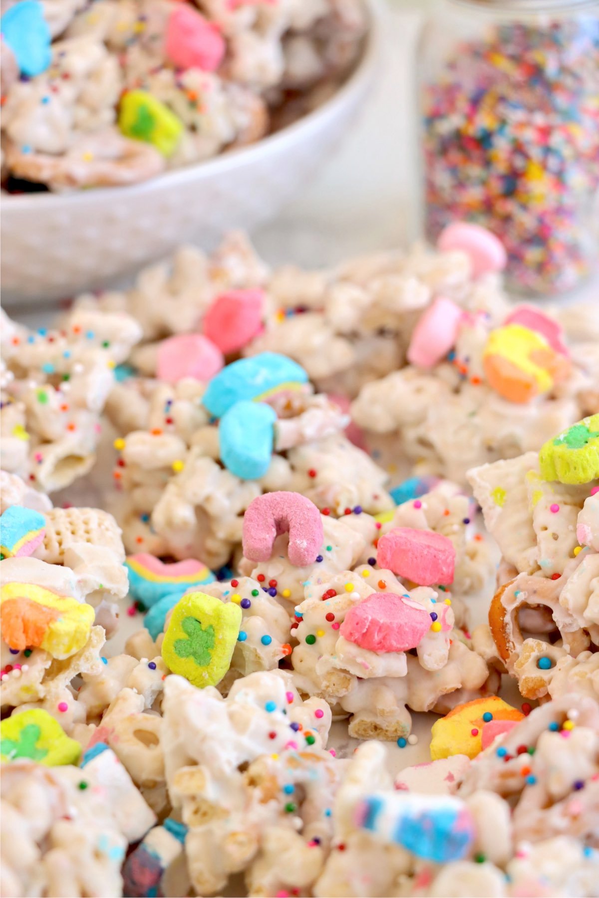 St. Patrick’s Day snack mix, featuring crunchy clusters of pretzels, Chex, and marshmallow pieces coated in vanilla almond bark.