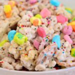 A bright and festive mix of coated cereal and pretzels, topped with vibrant marshmallows and rainbow sprinkles.