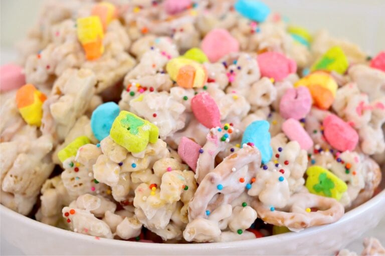 A bright and festive mix of coated cereal and pretzels, topped with vibrant marshmallows and rainbow sprinkles.