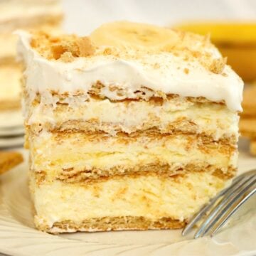 A layered Banana Pudding Icebox Cake topped with whipped cream and banana slice.