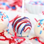 Decorated 4th of July cake pops lined up on a tray.
