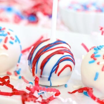Decorated 4th of July cake pops lined up on a tray.